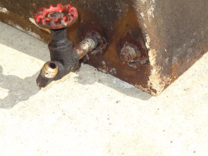 Port tank fuel feed at bottom inside corner at aft end of tank - old gate valve in place - no evidence of rust around the fittings