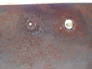 Top side of port fuel tank viewed from inside of tank- showing holes around fill and vent fittings